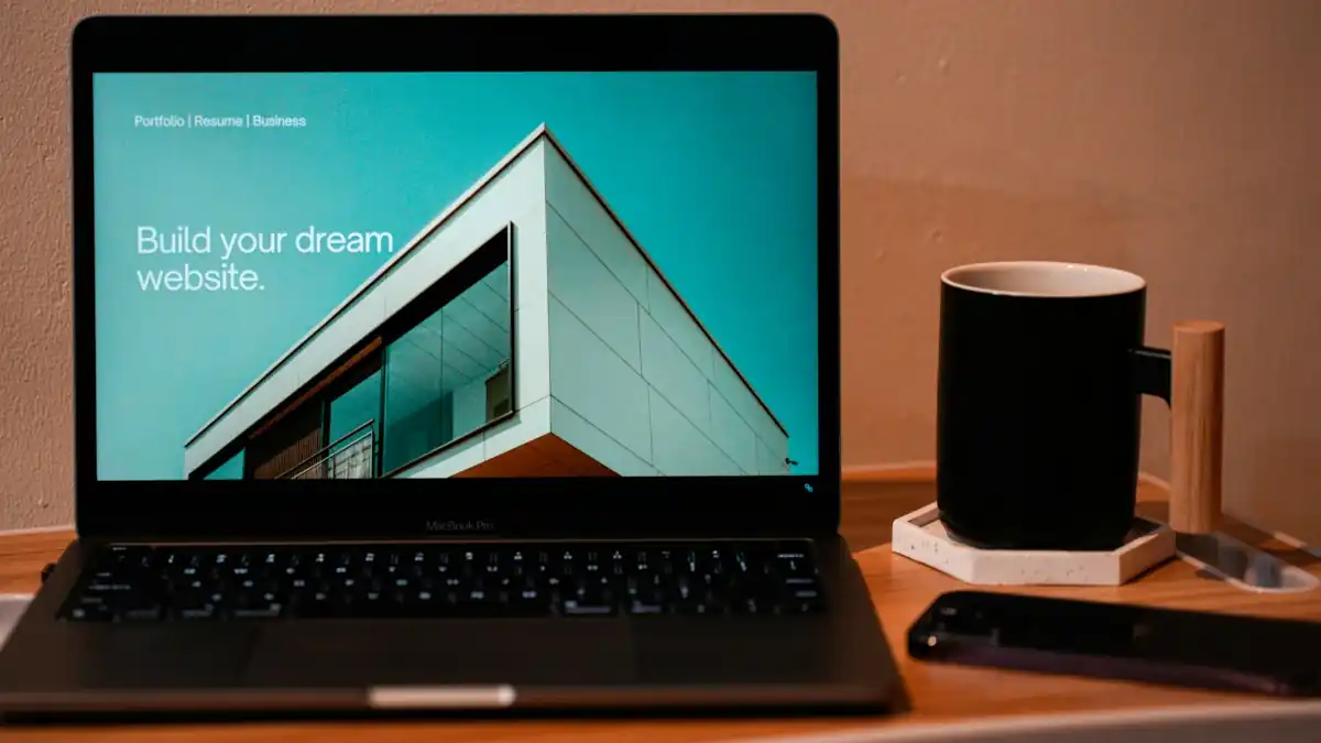 Dream website on laptop with a cup of coffee